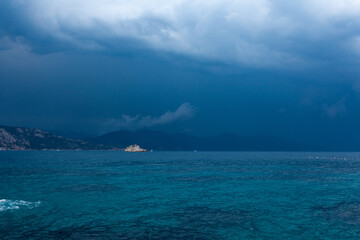 Blue sea and clouds in a blue stormy sky