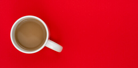 Top view, flat lay of black coffee cup on background red.