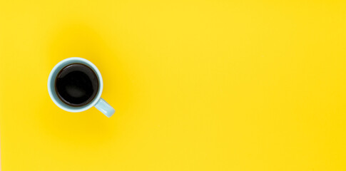 Top view, flat lay of black coffee cup on background yellow.