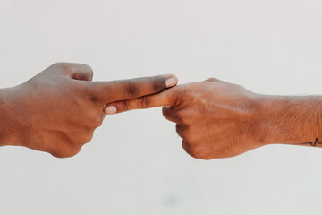 Two finger of different color touching each other. End Racism concept