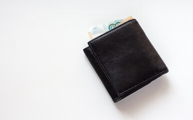 black leather wallet with Russian money on a white background