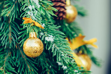 Green fir tree with golden balls. Christmas wallpaper.