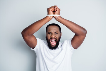 Photo of furious dark skin african guy citizen antiracism group leader showing tied with rope arms freedom express rights protest fight unlit very end isolated grey color background