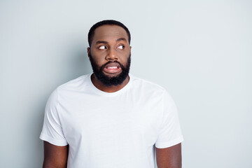 Photo of terrified dark skin african young guy look white people hate dislike afraid walk street...