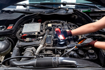 Fototapeta na wymiar mechanic looking for a fault on a compressor engine using a flashlight