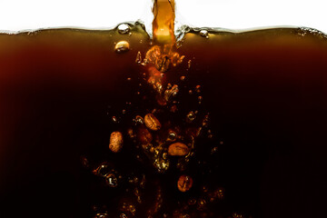 Closeup process of making, pouring aromatic espresso coffee. Macro shot of dipping, falling roasted...