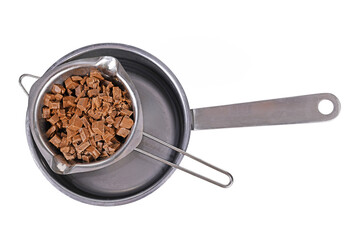 Top view of chocolate pieces for baking in water melting bowl in pot on white background