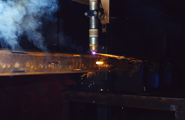 a plasma cutting machine cuts perforations on a pipe. Production of a well filter for use in oil...