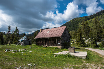 Fototapeta na wymiar Mountain hut in Lomska duliba. Lomska duliba is a glacier valley with and is located between Veliki Rajinac to the north and Hajdučki kukovi to the south of Northern Velebit mountain.