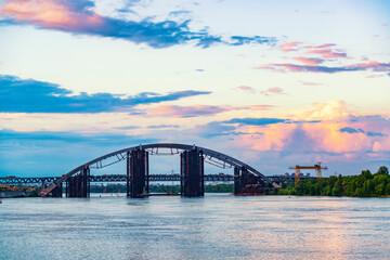 Modern arch bridge at the sunset.