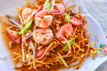 A twist on traditional salads, Fried Papaya Salad..Deep fried papaya with shrimp serve with Thai style sauce.Thai food - green papaya salad with mixed dried shrimp or dried salted prawn (som tum thai)