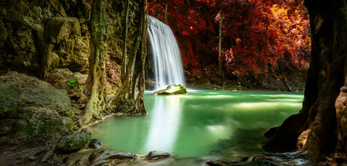 Colorful majestic waterfall in national park forest during autumn, panorama - Image
