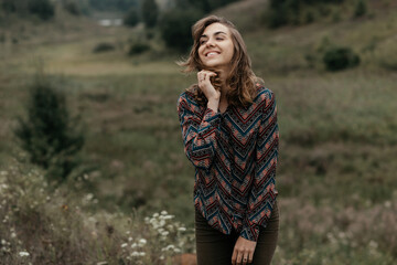 Happy woman standing in nature and smiling