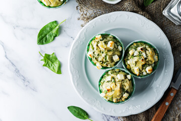 Spinach Feta cheese breakfast muffins with fresh spinach leaves