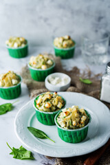 Spinach Feta cheese breakfast muffins with fresh spinach leaves