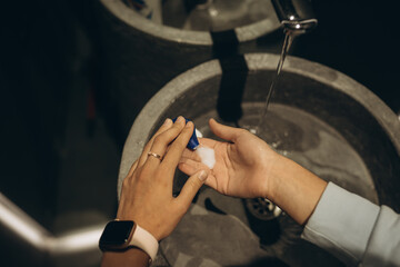 Woman washing hands to protect against the coronavirus