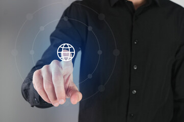 Business man pressing a  world icon button on a virtual digital  interface. Network concept..