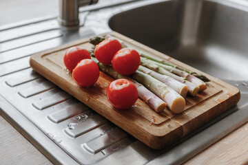 washed tomatoes and asparagus on the board 