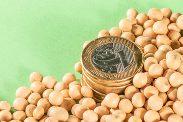 Soybeans and brazilian Real coins on a green background in Brazil