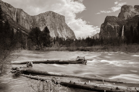 Sepia image from the floor of Yosemite valley with mountains, waterfall, and river