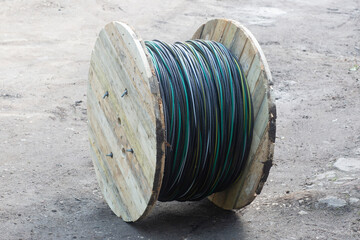 Fototapeta premium Electric cable of great length in a wooden Bay. Laying a new electrical cable.