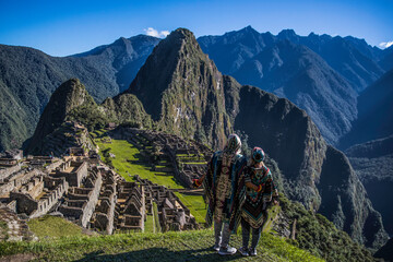 Couple watching the ruins of Machu Picchu in Peru