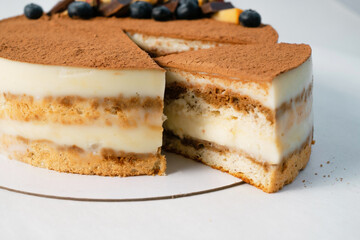 Homemade cake on white table. Food delivery. Homemade baking. Close up side view.