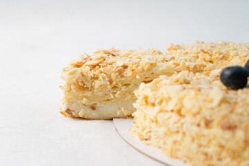 Homemade cake with nuts on white table. Food delivery. Homemade baking. Close up side view.