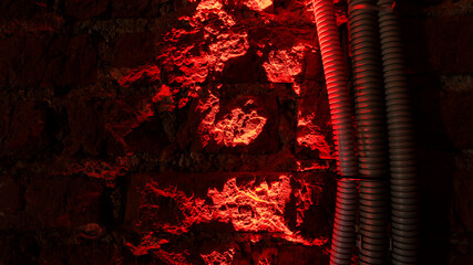 Red light on a background of dark red red brick wall. Space for text. Abstract background.