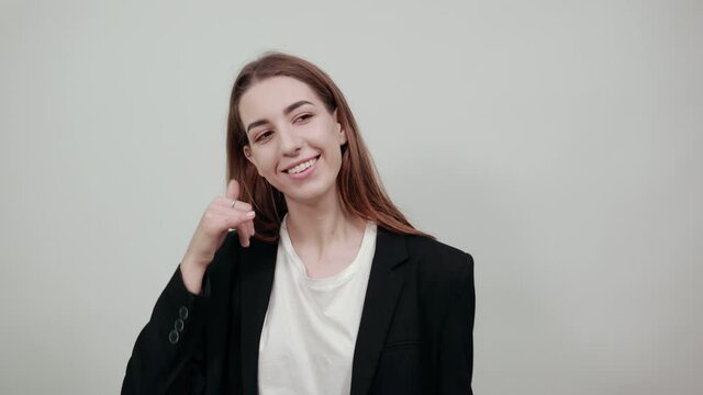Imitates telephone conversation, keeps hand near ear as if holding mobile phone. Talking on smartphone simulates. Call with her finger. Asks to recall. Pretending that speaking with somebody