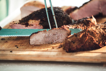 Several pieces of roasted beef meat laying on wooden board. Celebration, party, birthday or wedding concept.