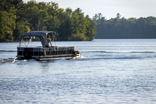 pontoon boat with canopy on lake