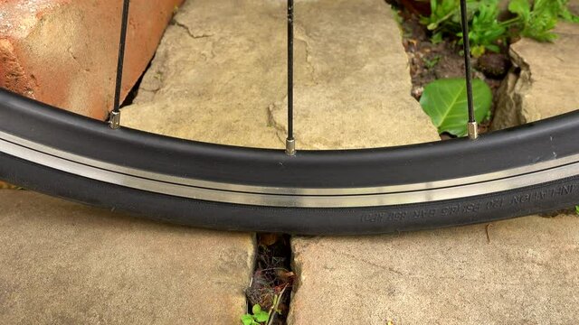 Road bike tyre going flat, close up.