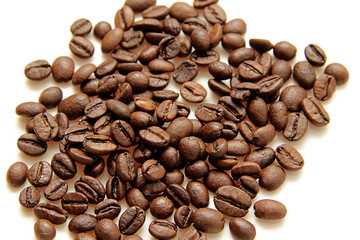 coffee beans are scattered on a white background
