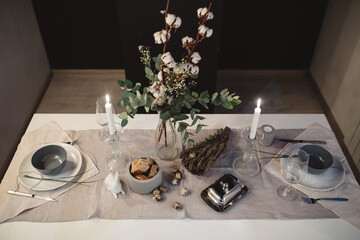 candlelight dinner for two with bread on a white table with cutlery