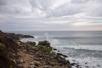 wave crashes on bech at sunset