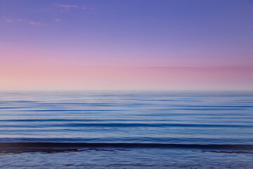 Beautiful light sunset over Baltic sea. Natural background. Latvia. Afterglow, evening calm on the Sea