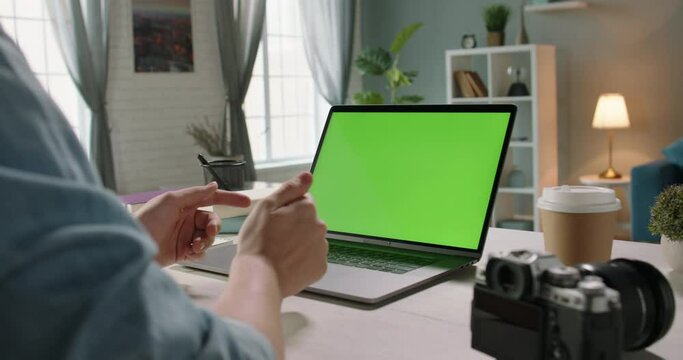 A freelancer has a video chat with employer, gesturing. Remote worker using his chroma key green screen laptop for online conference - connection, technology concept 4k template