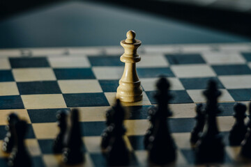 white queen figure against all the other enemy figures