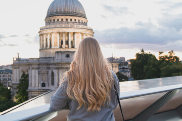 Blonde girl looking at St Paul's Cathedral in London