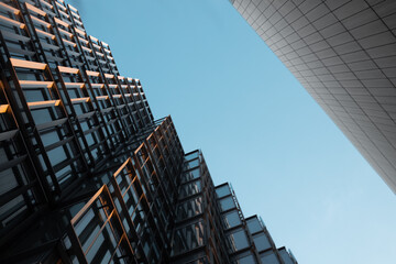 Look up at a modern urban facade of a business district geometrical building