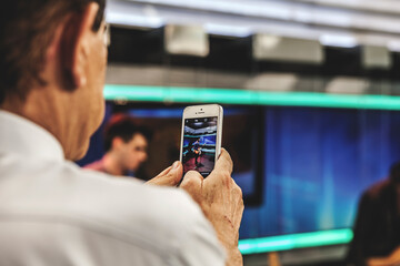 man taking picture with cellphone