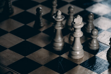 strategically playing chess with enemy player closeup king and queen figures