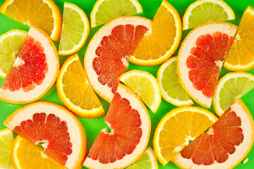 Fototapeta na wymiar fruit background, a mixture of slices of citrus fruits, a vitamin set of fruits, healthy natural products. Juicy ripe orange, lemon and grapefruit.