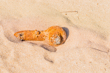 Rusted pipe in the sand