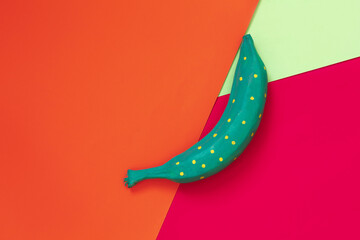 colored bananas on orange, blue cardboard