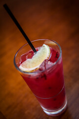 red drink with a lemon