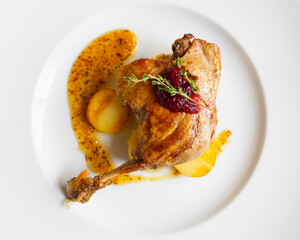 roasted duck leg with potato and mustard sauce, top view