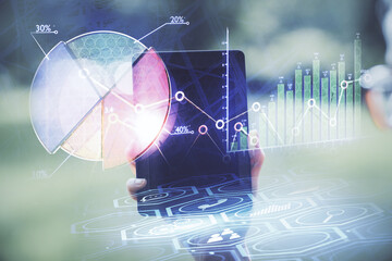 Double exposure of forex chart sketch hologram and woman holding and using a mobile device. Financial market concept.