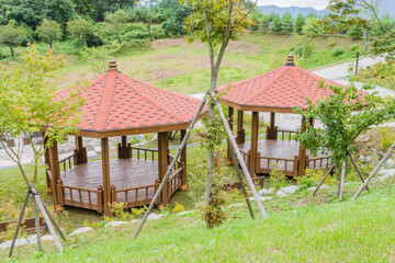 Two covered wooden picnic gazebos